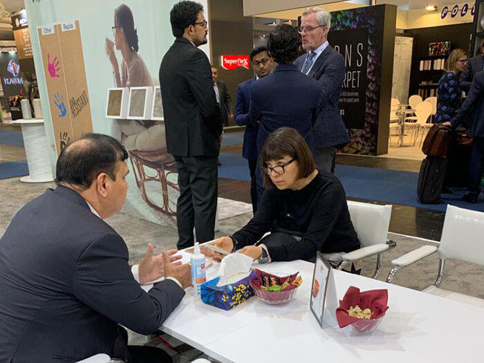 Discussion at a Textile Trade Show Booth