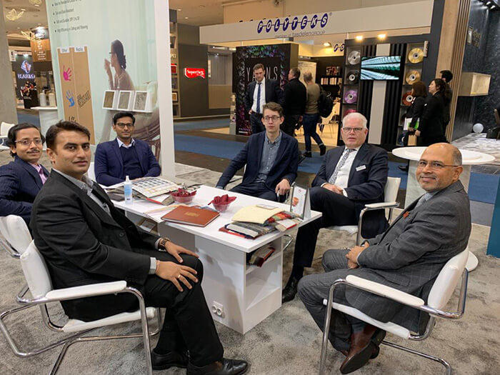 Professionals Meeting at an Exhibition Booth