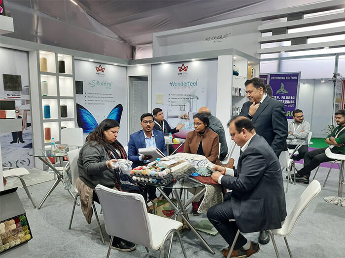 Discussing Textile Samples at Trade Show India