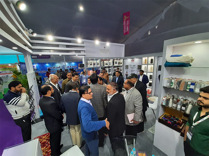 Professionals Discussing Products at the Trade Show India Booth