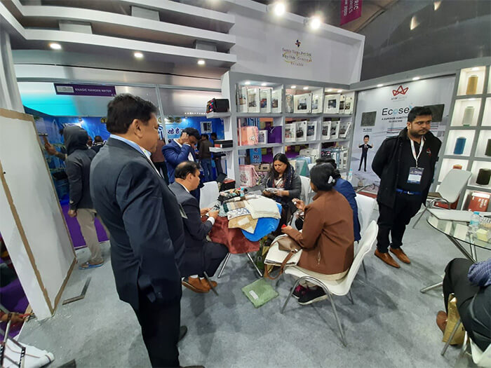 Professionals Observing Products at the Trade Show India Booth